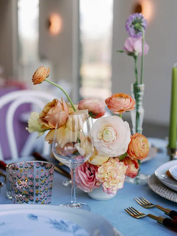 A table with flowers and wine glasses on it