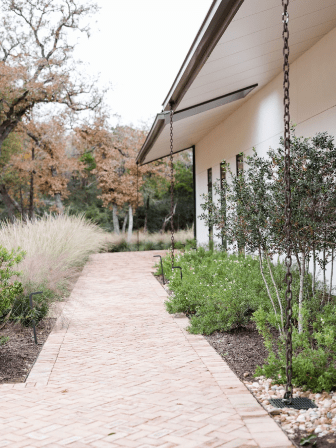 A brick walkway in front of a house.