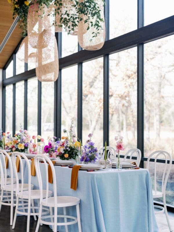 Light blue table with floral centerpiece.