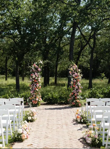 Floral wedding ceremony aisle and arch.